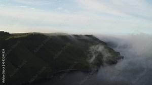 Scenic aerial flyover view of Isle of Skye shoreline / Portree, Scotland