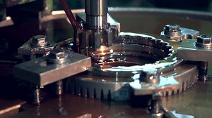 Engine oil lubricates the metal gear of the lathe during operation work. slow motion industry. Oil lubrication of heavy machinery. The use of engine oil in the metallurgical industry