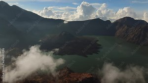 Active volcano Rinjani. Lombok. Indonesia. Drone flights over the crater. A lake with acid. Eruption. A pillar of smoke. High quality 4k drone footage