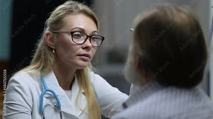 Neurologist checking pupillary reflex with flashlight Stock Video