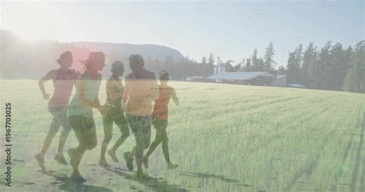 Five female runners entering from left, jogging across field, sunlight causing ghosting for fitness