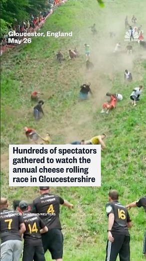 Hundreds of spectators gathered to watch the annual cheese rolling race in Gloucestershire