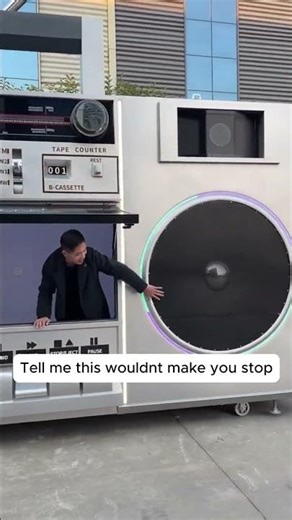 A radio shaped storefront in the middle of the street.⁠ ⁠ ▶️ No copyright intended