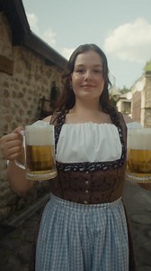 Woman in Dirndl holding Beer Mugs | Free Stock Video Footage
