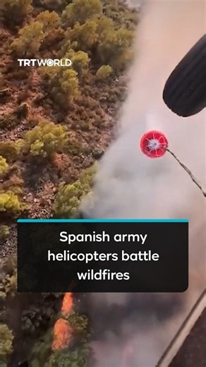 Spanish army helicopters deploy water drops to combat wildfire