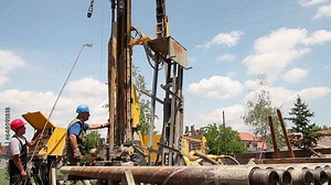 Drilling Rig Workers Drilling Geothermal Well for a Residential Geothermal Heat Pump. Geothermal Drilling Rig. EU Countries Invest in Geothermal Energy. Renewable Energy Source. Green Energy.
