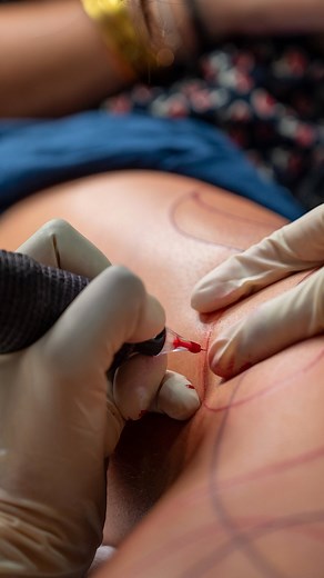 Aliens Tattoo on Instagram: "Come, experience what goes into the making of a beautiful tattoo, where every motion tells a story. From the gentle pour of ink to the careful placement of the stencil, watch as a simple vision becomes a work of art. Feel the hum of the machine blend beautifully with the rhythm of creativity, bringing Beth’s tattoo to life, expressing a bond with two delicate lines, minimal yet bold, etched with love. This connection has now found its way onto the skin, a witness to