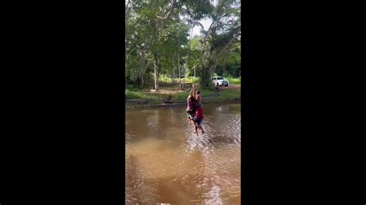 Children enjoy rope swing fun by the river in Mossoró, Brazil