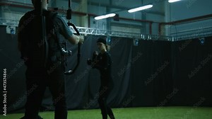 Cameraman filming actors performing some fight moves wearing motion capture suits as a game characters. Motion capture is an unparalleled method for making animated characters move more realistically