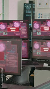 Vertical video: Desk with multiple monitors displaying error message on screen, computer server being hacked. Empty software developing agency office with system error security and hacking alert.