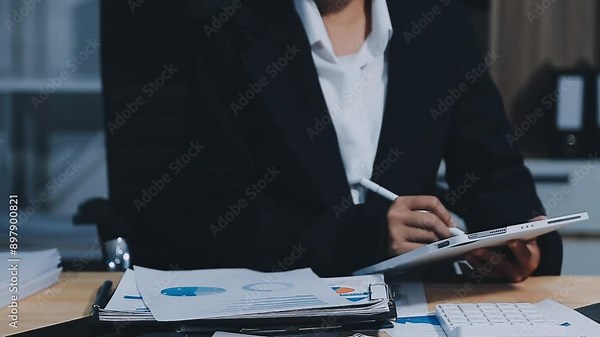 Asian accountant working and analyzing financial reports project accounting with chart graph in modern office, finance and business concept.