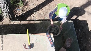 Woman bricklayer works in construction using and preparing cement for construction work gender equality and women entrepreneurs.