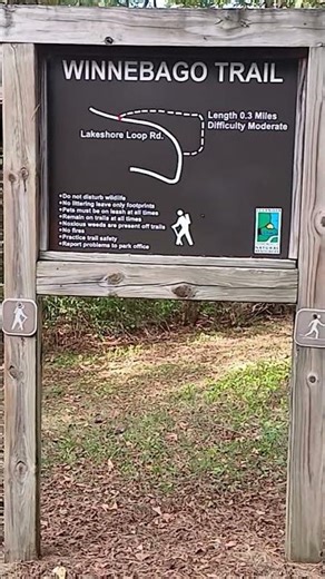 At Johnson-Sauk Trail State Recreation Area in Illinois in Fall Autumn is a Winnebago Trail sign.