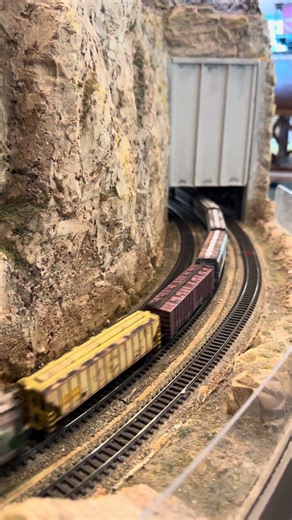 UP locos pull a weathered freight train.