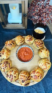 Every party needs that recipe — the one everyone asks for…. …this is that recipe! These buttery pizza rolls are made with biscuits, stuffed with pepperoni, olives, and mozzarella, then brushed with seasoned butter and baked until golden. They’re perfect for game day, Super Bowl snacks, or any get-together where you want something easy that everyone loves. Serve them with warm pizza sauce or your favorite dip… and trust me — make two pans. BAKE according to biscuit directions (I added 5 min more)