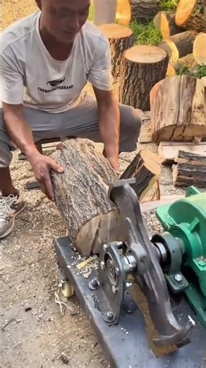 Splitting large wooden logs into several smaller pieces using powerful automatic wood splitter machi