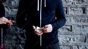 drug trafficking, crime, addiction and sale concept - hands of addict with dose and dealer counting money on street