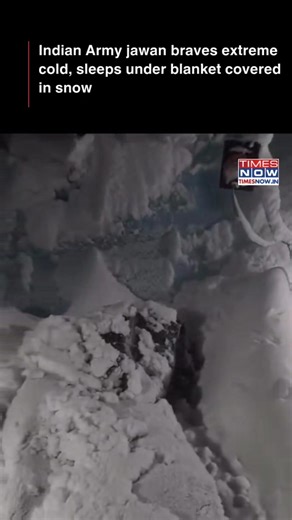 An Indian Army jawan is seen resting under a blanket covered with snow, highlighting the extreme weather conditions faced by troops during deployment. #TimesNow #TimesNowNews | TIMES NOW