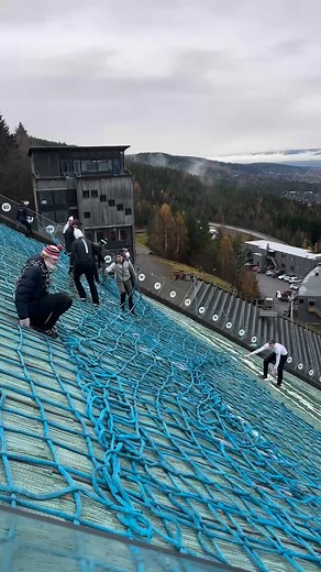 From green to white❄️ Ever wondered how the snow stays in place on the steep landing hill of a ski jump?🤔 The secret is a huge net, placed on the plastic mats used in summer, which prevents the snow from sliding down the hill and ensuring a consistent landing surface⛷️ Besides that, also the ceramic inrun used in summer is changed to an ice inrun🧊 📽️: @teamolympiaparken_hoppkombi #fisnoco #nordiccombined #wintersport #skijumping #hill #winter | FIS Nordic Combined