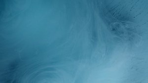 Colored smoke explosion on white pink blue ink