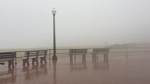 Rain and fog on the Ocean Grove boardwalk as storms hit the Jersey Shore