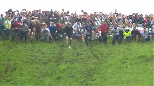 Man breaks record for most wheels of cheese won in annual cheese rolling race in U.K.