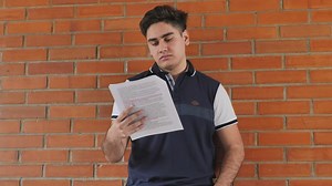 Young man studying in the corridors of his school - Free Stock Video