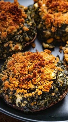 These spinach and feta stuffed portobello mushrooms aren’t a side dish - they’re dinner. Recipe link in bio. Follow @thegeneticchef for more delicious recipes! Ingredients 2 tablespoons olive oil 1 medium sweet onion diced 1 pound bag frozen chopped spinach 2 tablespoons fresh chopped dill ¼ cup plain breadcrumbs 1 large egg ¼ cup pine nuts 4 ounces feta crumbled 4 large portabella mushrooms Topping: 2 tablespoons butter ½ cup plain breadcrumbs #stuffedmushrooms #dinnerideas