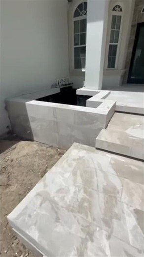 This travertine install completely changed the look of this space.
