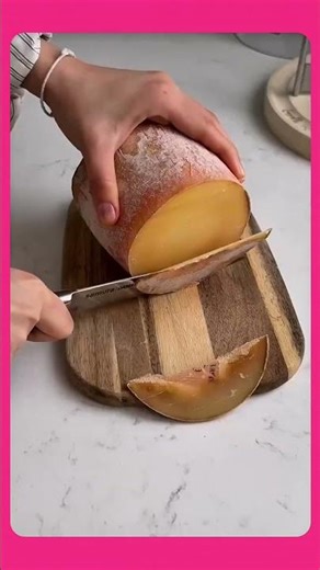 Edam cheese shaved into delicate, paper-thin slices with a sharp hand slicer, smooth and satisfying.