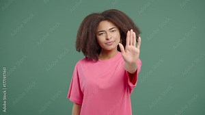 Serious woman with open palm in stop gesture, clear assertive body language