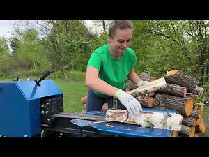 Beautiful Girl Splitting Logs on a Powerful Kinetic Wood Splitter