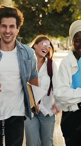 Group of students running in the street going to college school celebrating graduation