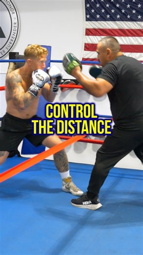Long Range Boxing Training Drill | Distance Control & Footwork Technique 🥊 Learn proper boxing distance management with this mitt work drill! The Arena’s Boxing Coach Joe Vargas @joe_hits creates a barrier using hand wraps to teach fighters long range boxing technique with Fighter Kyle Erwin @kyleboxeo. The drill focuses on reactive footwork - mirror coach’s steps while staying outside danger zone and landing clean combinations. Key boxing technique: Angle rear foot toward opponent for maximum 