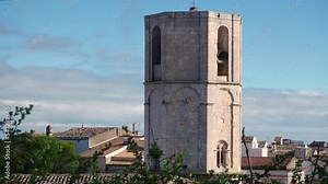 Bells toll loudly (with audio) from an old church bell tower over an Italian town