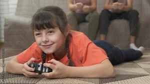 Girl with modern joystick. A family with child have free time with playstation game in the room.