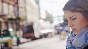 Young attractive woman looking at a street map outside, in slow motion