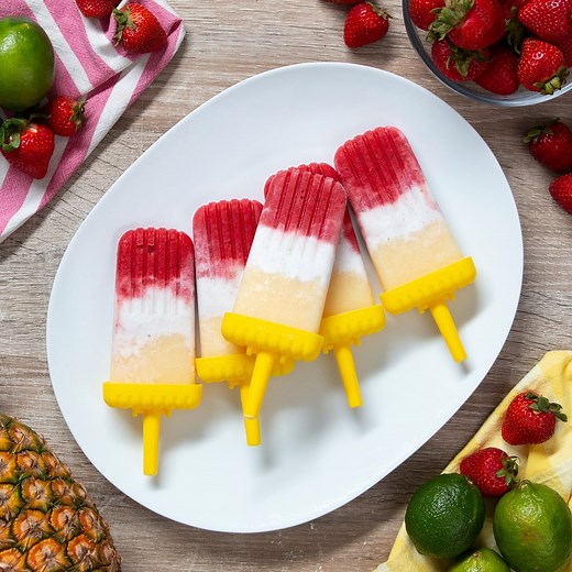 These colorful, fruity, and boozy ice pops are a surefire summer hit! Layers of strawberry daiquiri, sweet coconut, and piña colada are fortified with coconut milk and rum for a creamy pop with a kick that is sure to get the party started! Recipe: https://tasty.co/recipe/strawberry-daiquiri-pina-colada-ice-pops | Tasty