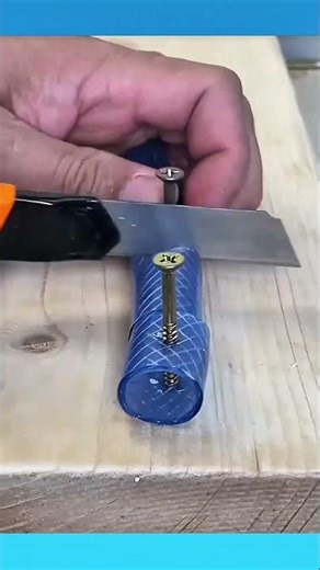 Cut water hose nailed to a board, creating simple spacers to keep network cables separated and safe.