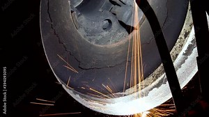 Technological process of applying thermal barrier protective coatings on elements of hot engine parts. Aviation. Repair of gas turbine engines. Sparks of hot metal close up.