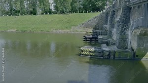 Huge door at overflow cargo lock chambers. Water dam on river with pass. Transport building for waterway navigation on river. Dripping water over surface.