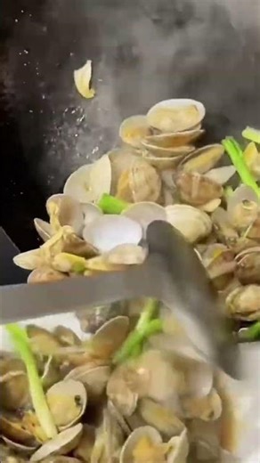 the stage of pouring a cooked shellfish dish onto a prepared plate#food