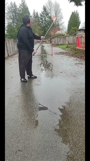 a dragon slayer in the rain with a bat flip at the end of it #trickshot #hockey #NHL