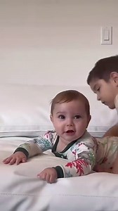 Family puppy pile turns into cutest baby smile moment