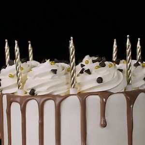 1.1K views · 170 reactions | A Little Bit Fancy Deluxe Birthday Cake - for those who like it extra special on their birthday  Vanilla sponge layered with caramel cream and gooey caramel. Coated in icing crème and finished with a milk choc drip, rosettes, gold pearls and choc chips. Add candles and an acrylic topper to complete the look! Order Online. A 3 day pre-order period applies. https://www.cheesecake.com.au/our-cakes/party-cakes | The Cheesecake Shop | Facebook