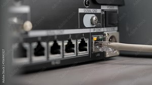 flashing LED in a server rack with RJ45 connectors and fiber optic cable. Network patch cable connected to switch in server room of internet data center