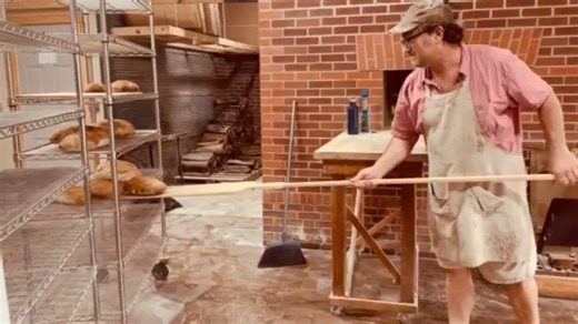 More fun than conventional ovens! Long-time baker Zack Folkers pulling Country French Batards out of the woodfired brick oven. | Serenity Farm Bread