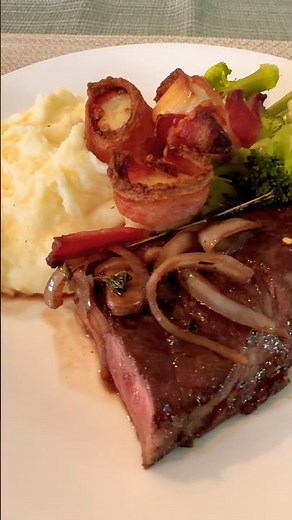 Steak, bacon- wrapped scallops on mashed potatoes