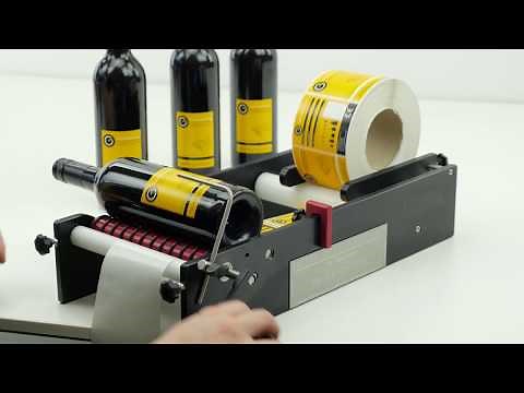 Wine Bottle Labeller - Wine Bottles being Labelled on the BenchMATE Label Applicator
