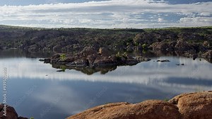Time lapse of clouds and water reflections on a scenic mountain lake